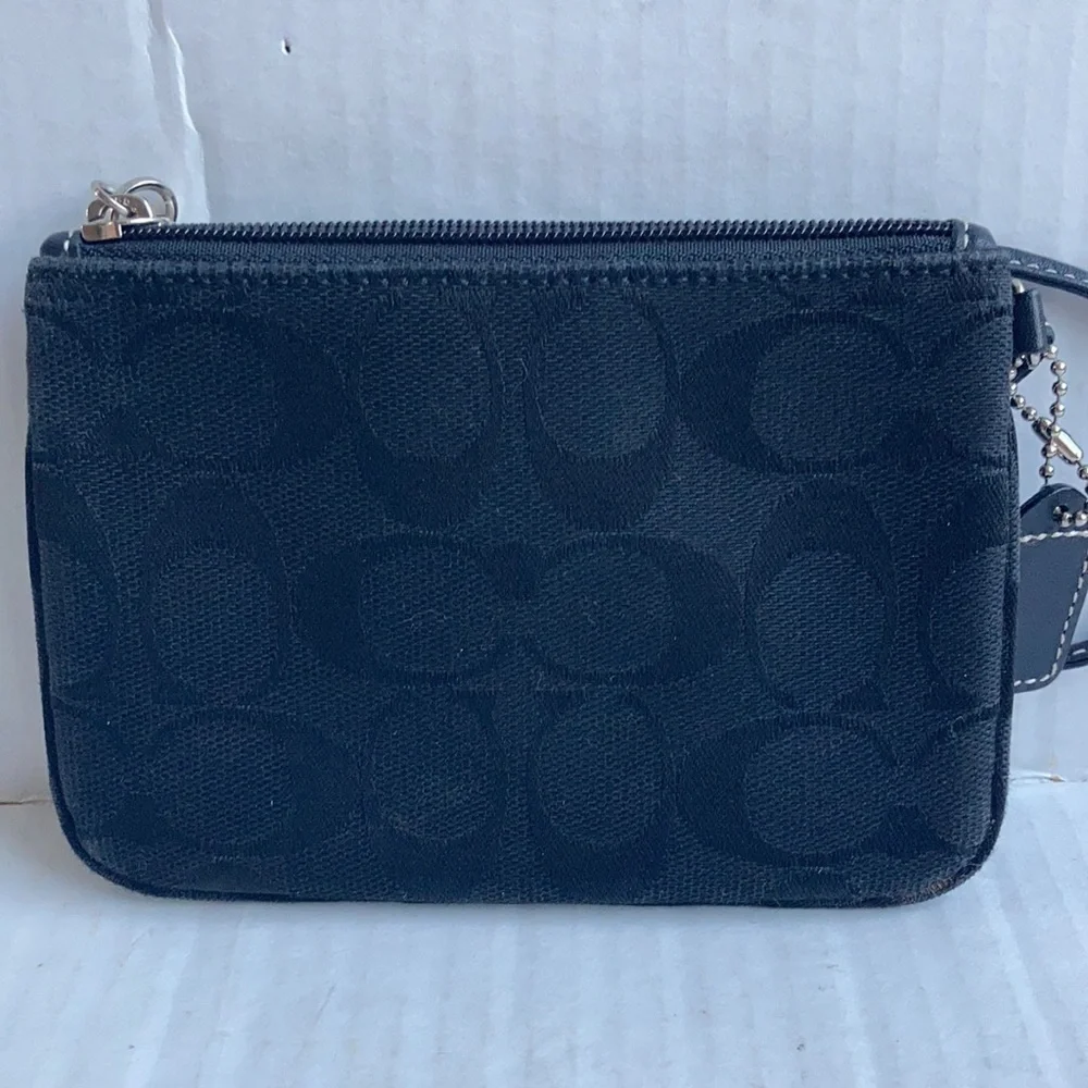 Coach black signature C mini wristlet.